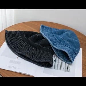 Detailed macro view showing the denim texture and stitching on casual bucket hats