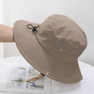 Detail view of khaki quick-dry sun hat with side metal vents and adjustable drawstring