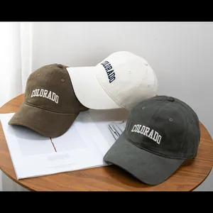 Detailed view of three colored brushed cotton baseball caps with Colorado embroidery