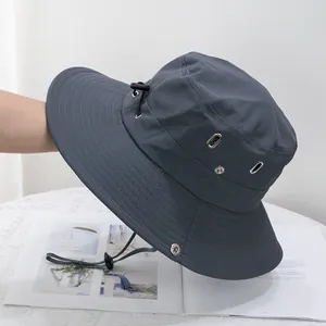 Close-up of charcoal sun hat with side snaps, vent holes and adjustable drawstring