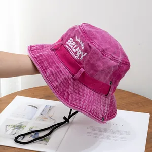 Close-up of rose red washed cotton bucket hat with white embroidery and windproof cord