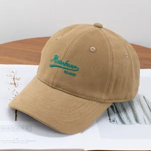 Detailed view of khaki brushed cotton baseball cap with green Mizoobean 1987 embroidery