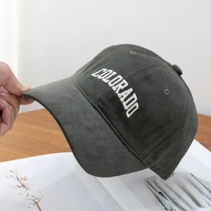 Detailed view of the Colorado embroidery on a charcoal grey soft cotton baseball cap