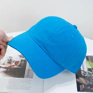 Detail of bright blue cotton baseball cap featuring reinforced stitching and breathable eyelets