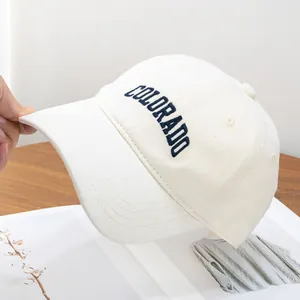 Detail of Colorado embroidery on cream brushed cotton baseball cap with curved brim