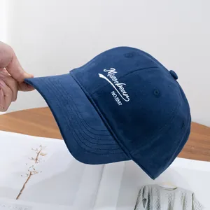 Detailed close-up of navy blue brushed cotton baseball cap with white Misoobean embroidery