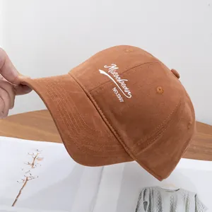 Close-up of caramel cotton baseball cap featuring white Mizoobear embroidery detail