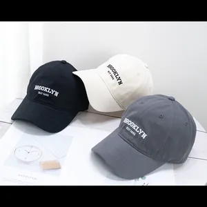 Neutral cotton baseball caps with Brooklyn embroidery in black, beige, and grey colors