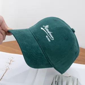 Detail of dark green corduroy baseball cap with white Misoobean embroidery
