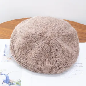 Close-up of soft mohair knit texture on an oatmeal warm wool beret for women