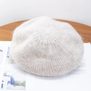 Detail of plush mohair knit texture on a soft beige beret hat for autumn and winter