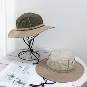 Detail of wide brim hiking hat showing mesh eyelets and adjustable windproof cord