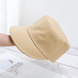 Detailed texture of cotton twill bucket hat in beige with white adjustable wind rope