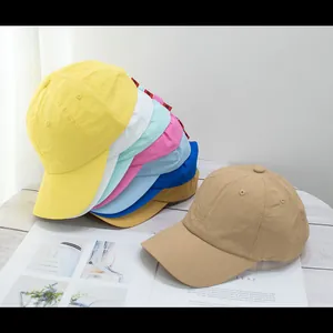 Lightweight quick-dry baseball caps in multiple colors on a wooden surface