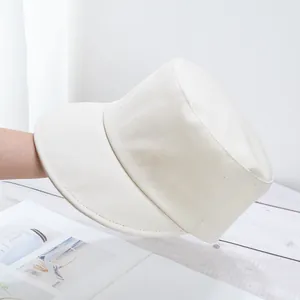 Detail of a minimalist cream white twill cotton fisherman hat with a wide brim