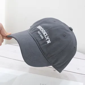 Close-up of deep gray cotton baseball cap with white 3D Brooklyn EST 1631 embroidery