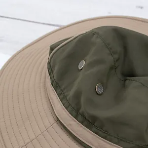 Detail of outdoor sun hat featuring metal mesh side vents and premium stitching