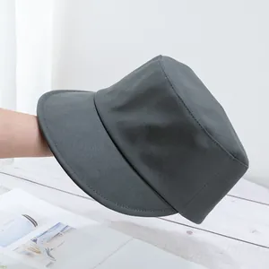 Detail view of structured dark grey bucket hat showing high-quality twill cotton texture