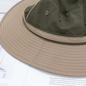 Detail of wide brim bucket hat with dual-color stitching and metal mesh side vents