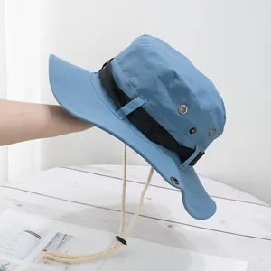 Detail of blue outdoor boonie hat showing metal air vents and adjustable chin strap