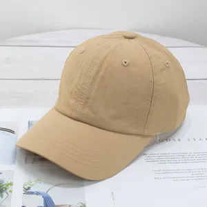 Close-up of quick-dry baseball cap showing light khaki fabric texture and reinforced stitching
