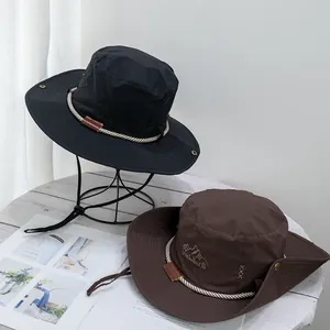 Detail of wide brim sun hats in black and brown with Travellers embroidery and wind cords