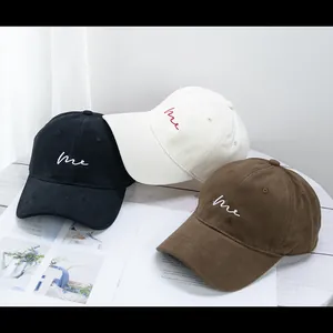 Three minimalist brushed cotton baseball caps with me embroidery in black, white and brown