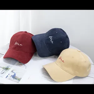 Three cotton baseball caps in burgundy, navy and beige with me embroidery on magazine