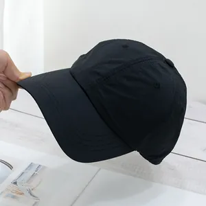 Close-up of lightweight black quick-dry nylon baseball cap fabric and stitched brim