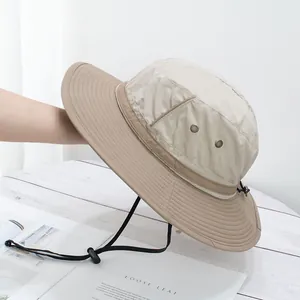 Close-up of khaki sun hat featuring breathable metal eyelets and a durable chin strap
