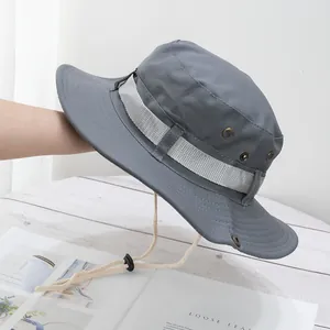 Detail of grey outdoor sun hat with metal air vents, reinforced strap, and windproof cord