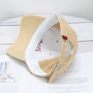 Internal view of khaki cotton baseball cap with adjustable strap on white wood background