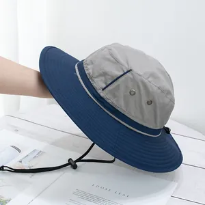 Detail of outdoor sun hat with blue-grey stitching, breathable vents and adjustable wind rope
