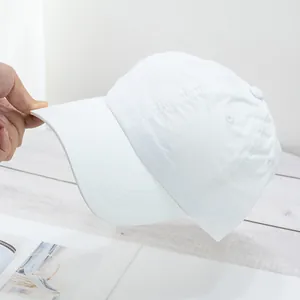 Detail of white quick-dry baseball cap with reinforced stitching and breathable holes