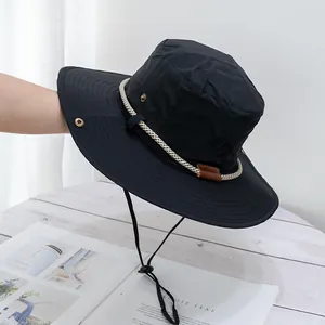 Detail of black outdoor sun hat with windproof rope, traveler embroidery and metal eyelets
