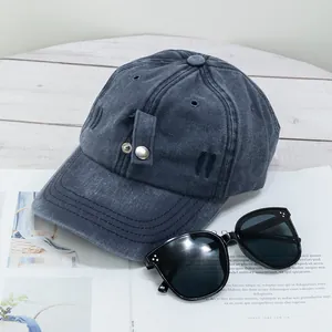 Détail de casquette de baseball en coton délavé gris avec bouton et sangle décorative