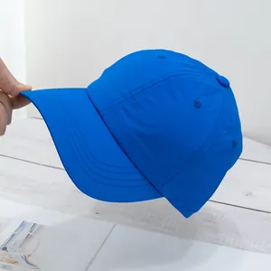 Close-up of bright blue quick-dry baseball cap with six-panel structure and curved brim