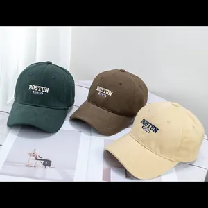 Detailed close-up of corduroy baseball caps with vintage Boston embroidery in three colors