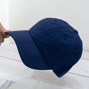 Detail shot of navy blue baseball cap showing six-panel crown and reinforced stitching