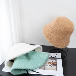 Close-up of fluffy faux rabbit fur bucket hats showing soft texture and inner ribbons