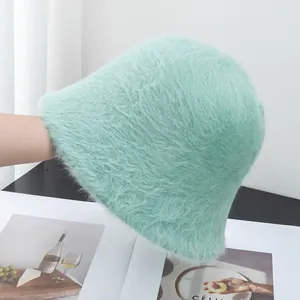 Detailed texture of mint green long plush bucket hat for women with soft faux fur finish