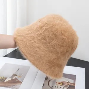 Close-up of light brown faux fur bucket hat showing soft plush texture and fluffy design