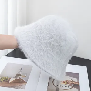 Detail showing the plush texture of a white faux rabbit fur bucket hat for women
