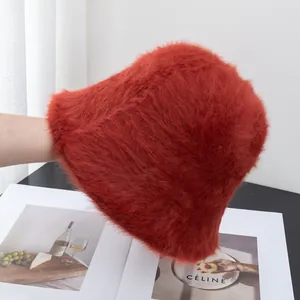 Detail of fluffy rabbit fur bucket hat in vibrant red with soft plush texture for winter