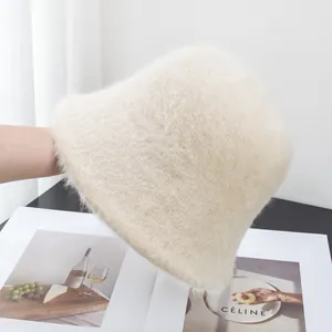 Detailed view of plush cream faux rabbit fur bucket hat with soft fluffy texture