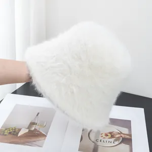 Close-up of white plush faux rabbit fur bucket hat showing soft texture and thick material