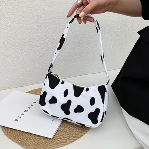 Fashionable cow print underarm shoulder bag for women with black and white patterns