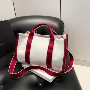 Large canvas tote bag with red trim and strap for women's daily commute in style