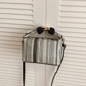 Chic striped woven straw shoulder bag with vertical gradient patterns and gold hardware