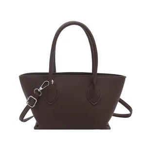 Classic dark brown pebble leather tote bag with top handles and adjustable shoulder strap